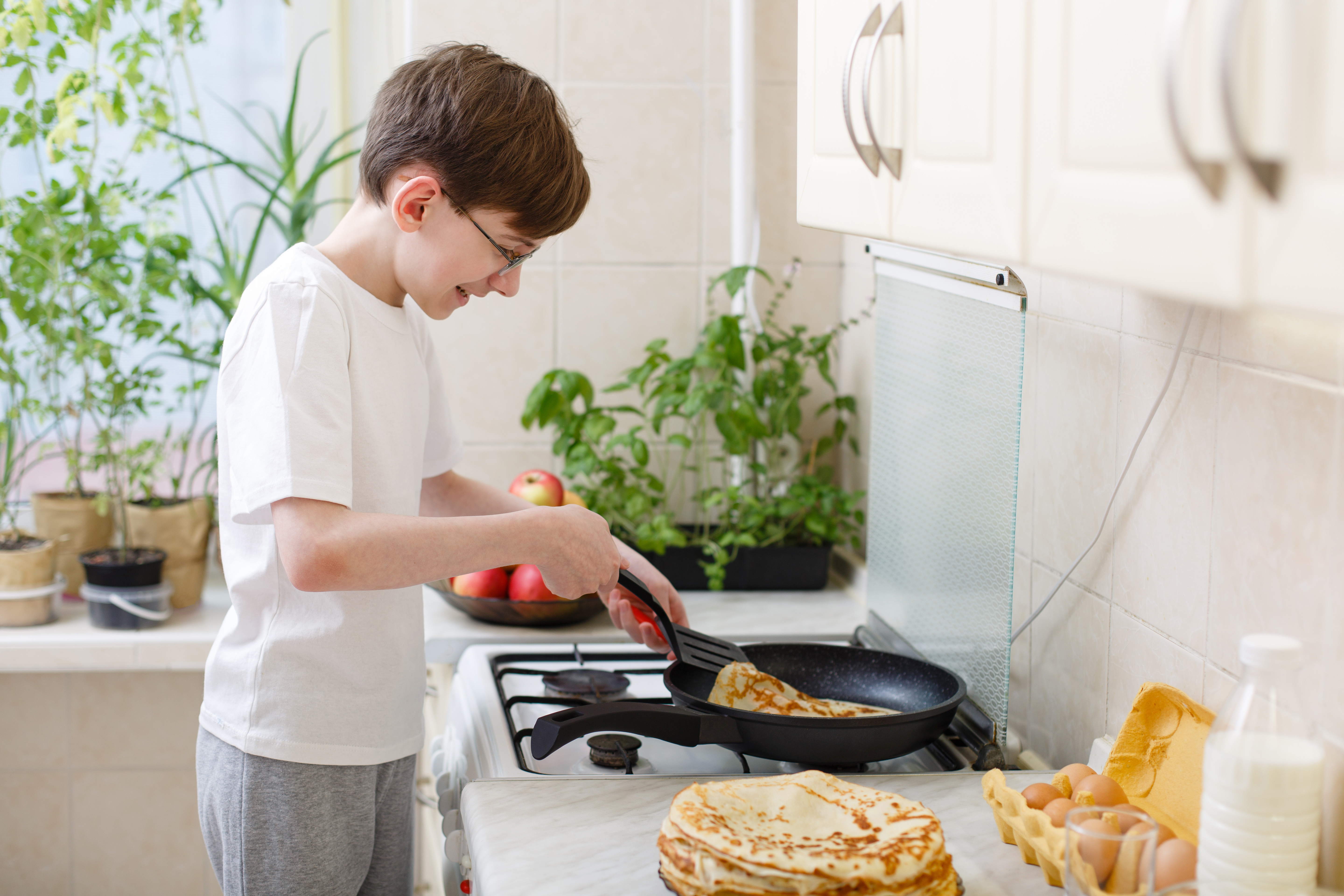 boy cooking pancakes